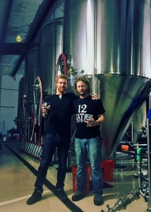 Shawn Kerr, right, standing in front of his first brew.